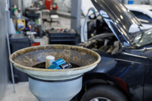 Used oil filters. A bowl for draining old engine oil in the garage workshop