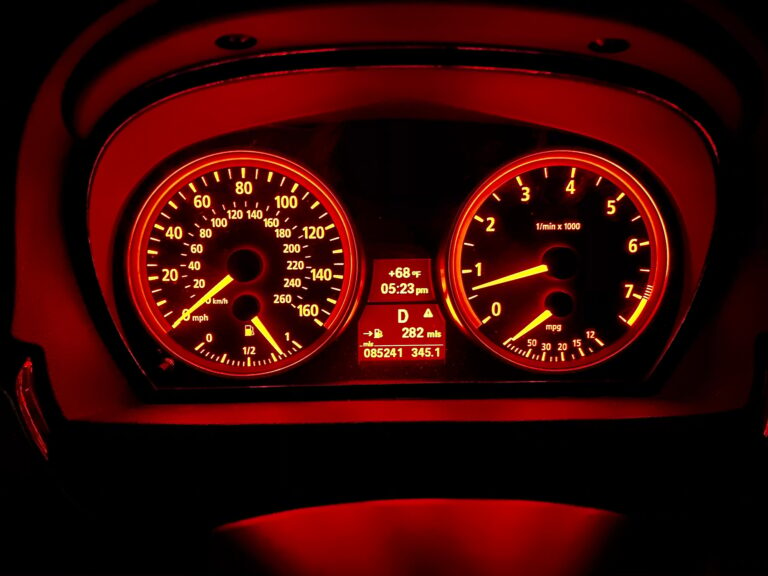 Driving on a road trip I’m a classic BMW 325i at night with an illuminated dashboard with gauges